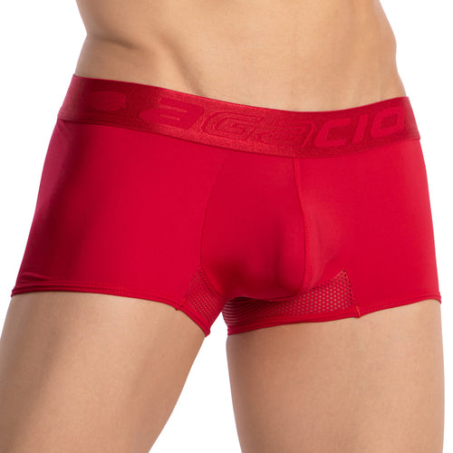 Close-up of a person wearing Agacio Breathable Back Boxer Trunk by Agacio, in red with a wide embossed logo elastic waistband. The fabric offers a supportive fit with side mesh panels for enhanced breathability. The persons torso is bare, focusing on the lower waist area.