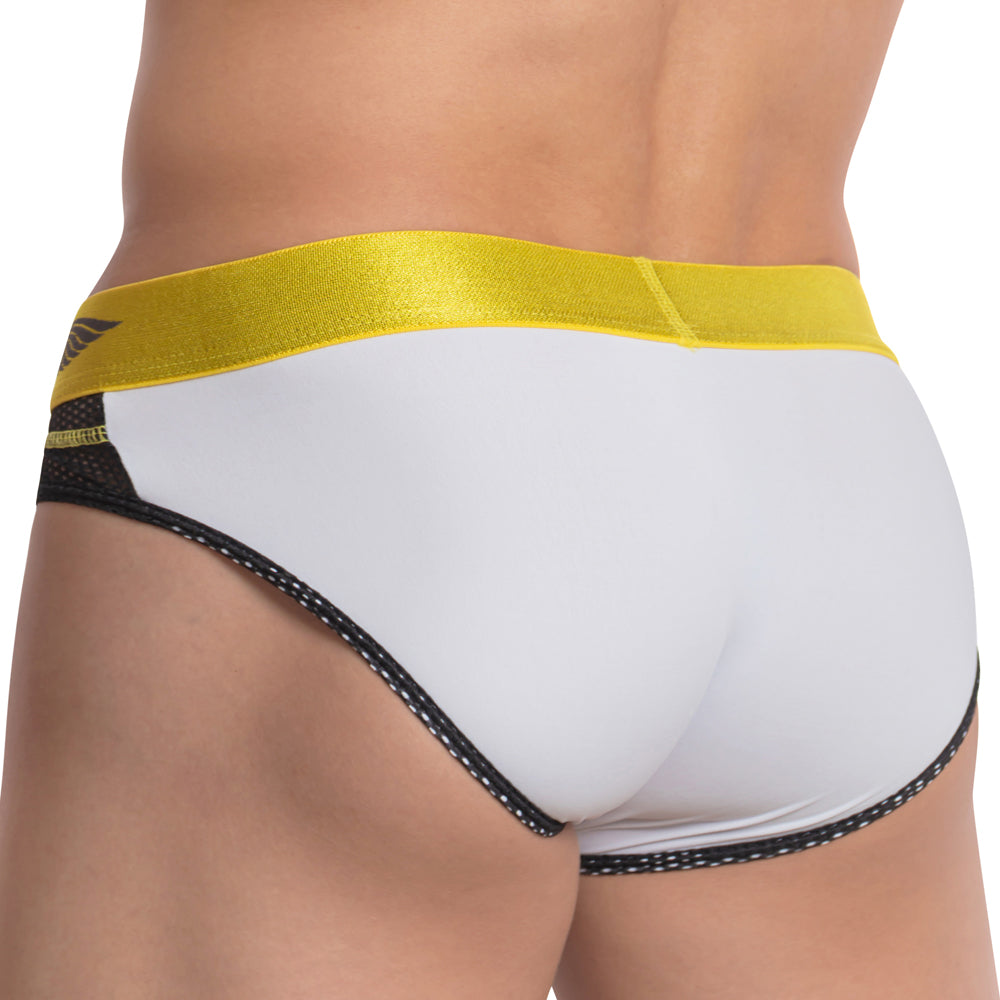 A rear view of a person wearing Agacio The Charged Brief in white and yellow showcases a classy, shiny waistband. Black trim contrasts elegantly with the vibrant design, while the breathable mesh ensures comfort and style.