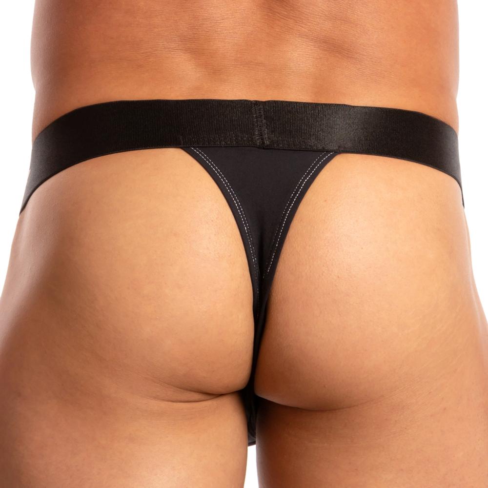 A person is seen from behind wearing an Agacio Chic Thong by the brand Agacio, featuring a thick waistband that accentuates their lower back and waist. The plain white background emphasizes the sleek design of this mens thong.