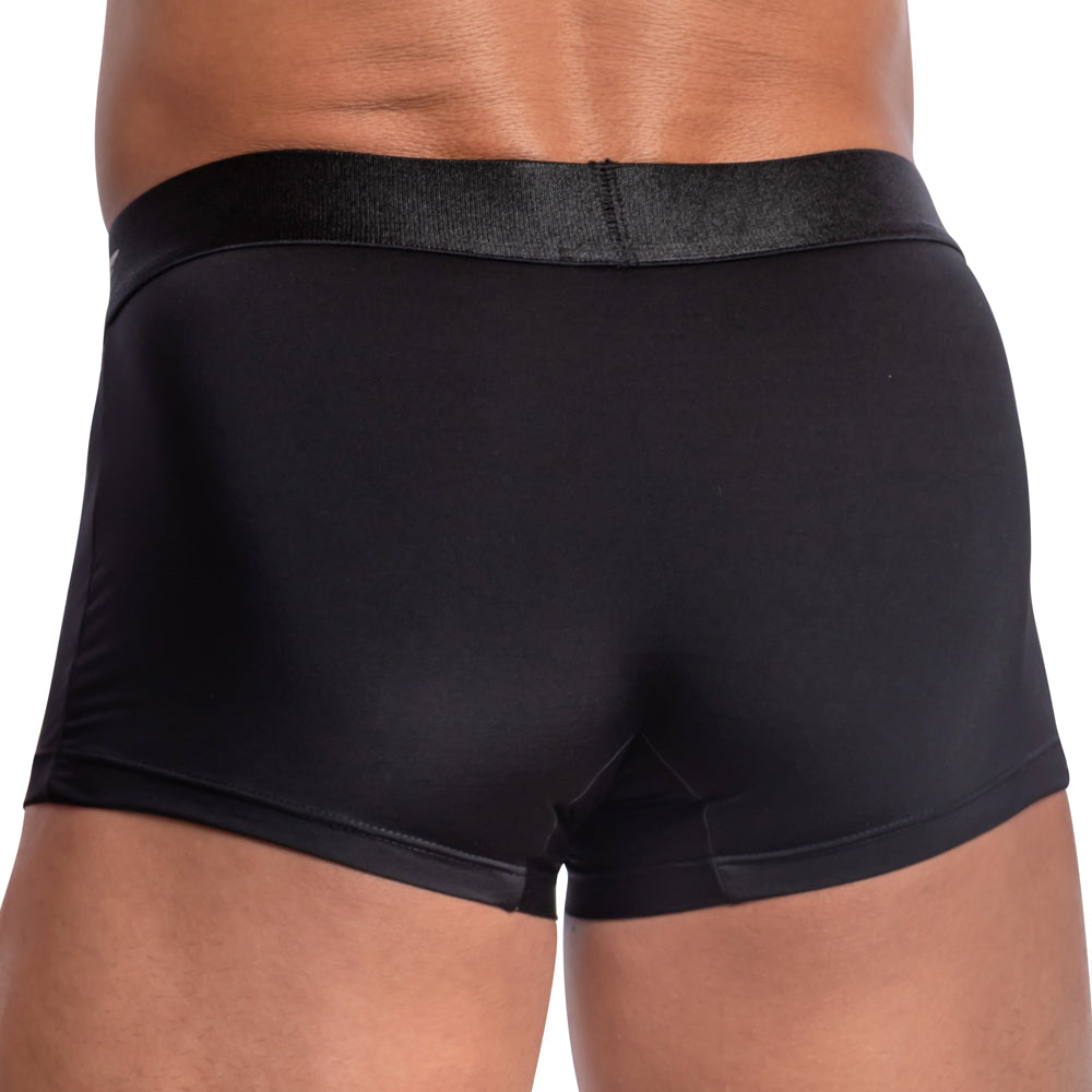 A close-up rear view of a person wearing black Agacio Contour Pouch Boxer Trunks from Agacio, highlighting the fit and material.