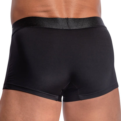 A close-up rear view of a person wearing black Agacio Contour Pouch Boxer Trunks from Agacio, highlighting the fit and material.