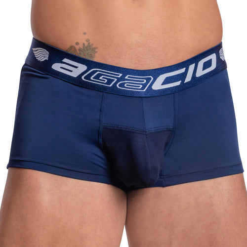 A person wears Agacio Contour Pouch Boxer Trunk in navy blue with a contour pouch. The Agacio brand is visible on the waistband, which offers comfort through breathable fabric, while a small tattoo peeks above the waistband.