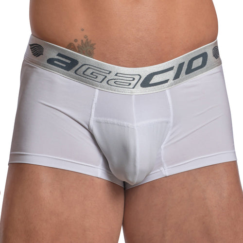A person wearing Agacio Contour Pouch Boxer Trunk in white, featuring a gray waistband with Agacio in bold. The boxer trunk is made of smooth, breathable fabric.