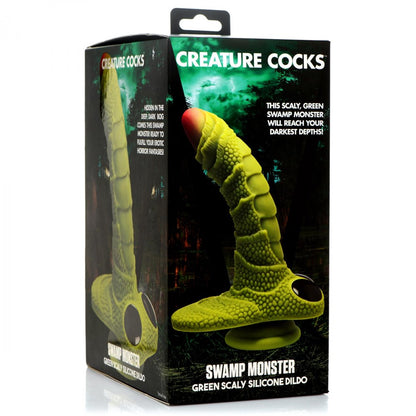 Box showcasing the Creature Cocks Swamp Monster Scaly Silicone Dildo in green. Made from phthalate-free silicone, it includes lush forest imagery and product details.