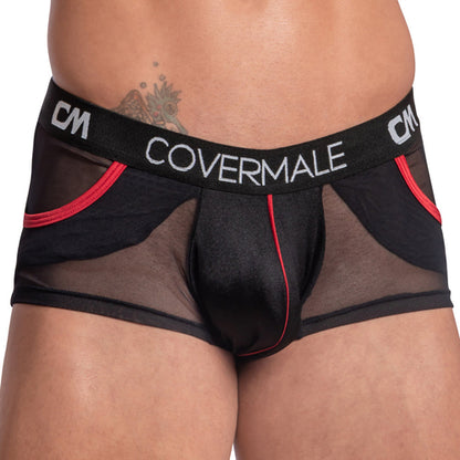 A person sports Cover Male Center Piping Boxer Trunks in black sheer mesh with red accents and a form-fitting design. The waistband displays COVERMALE CM, and a hip tattoo is partly visible.