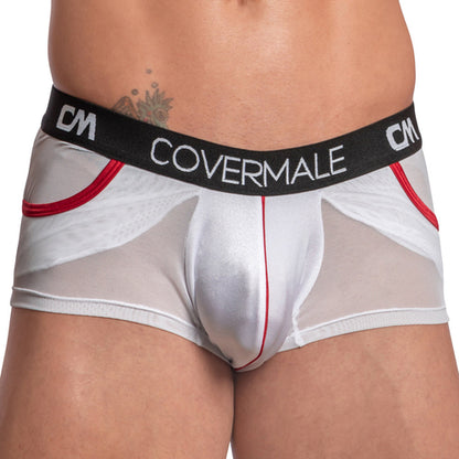 A tattooed hip is visible through the white sheer Cover Male Center Piping Boxer Trunks, which have a black waistband with Cover Male and CM logos and a form-fitting design featuring center piping and red side mesh panels.