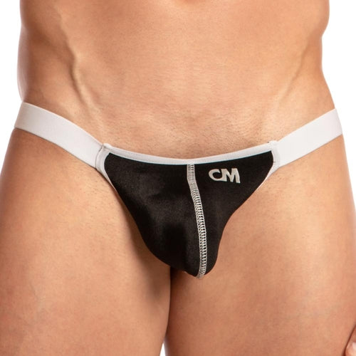 Someone is wearing a black and white Cover Male Striker Thong by Cover Male, featuring CM initials. It has a sporty design with a contoured pouch, a white waistband, and contrasting stitching for an athletic appearance.
