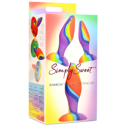 The Curve Novelties Simply Sweet Rainbow Silicone Butt Plug Set, made from body-safe silicone, comes in bright packaging with colorful plugs and the tagline Keep Things Nice & Sweet, ideal for beginners exploring anal training.