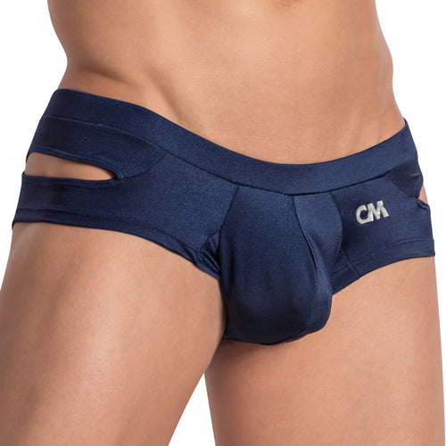 A person is wearing the Cover Male Shiny Pouch Jockstrap in navy blue with side cut design and shiny finish, featuring CM on the left. The image focuses on the lower torso and highlights its unique design.