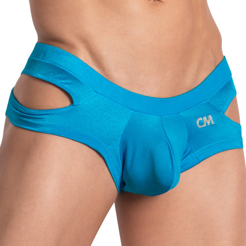 A person wearing the Cover Male Shiny Pouch Jockstrap with CM on the front. The vibrant blue fabric sparkles, and its side cut design emphasizes a distinctive fashion sense.
