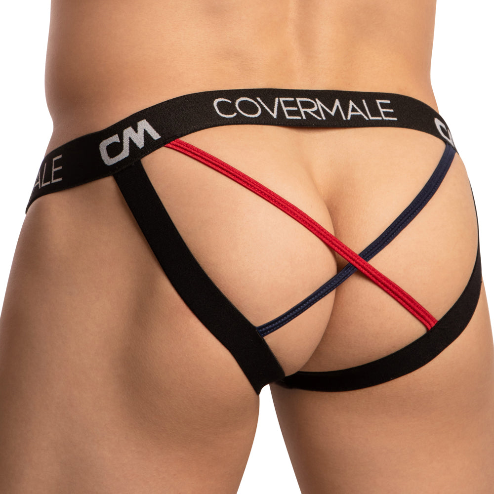 A person poses against a white background wearing the snug-fit Cover Male Cross String Back Jockstrap in black, red, and blue. The jockstrap has COVERMALE and CM on the stylish hip band and features alluring straps with two bands crossing at the back.