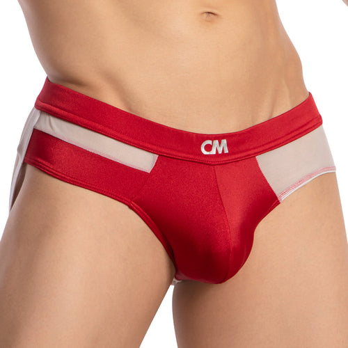 The image captures a person wearing the Cover Male Backless Beauty Jockstrap, featuring a red and white design. Made from silky, breathable fabric, it has a discreet logo on the waistband. The focus is on the lower torso and hips.