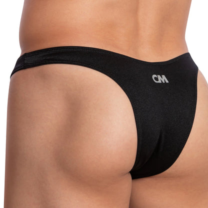 A close-up of someone in a Cover Male Mesh Pouch Bikini, showcasing a low-rise waistband made from quality polyamide-spandex. The small CM logo is visible on the side, highlighting the superior material and perfect fit.