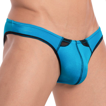 Close-up of someone in vibrant blue Cover Male Arctic Bikini, featuring a sleek two-tone design. The smooth fabric fits snugly around the waist, highlighting the front and side views of this Cover Male underwear.