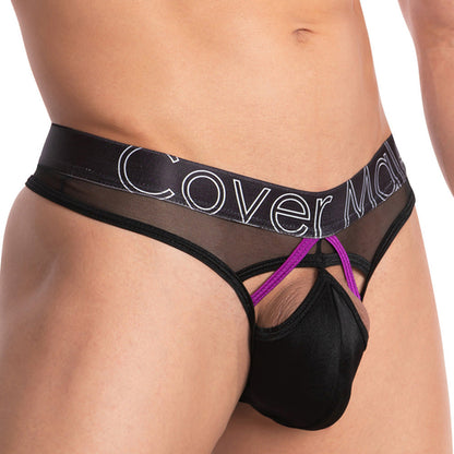 A close-up of a person wearing the Cover Male Doral Bikini highlights its sexy black and purple contrast, with a stretchable sheer waistband featuring Cover Male. Mesh and cut-out elements enhanced by bright lighting make this mens thong an irresistible choice.