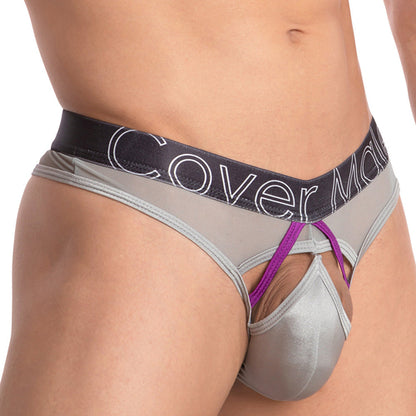 A close-up of a person wearing the Cover Male Doral Bikini in silver and purple, featuring a stretchable sheer waistband with text. This sexy design by Cover Male includes cut-out sections and striking fabric details for an eye-catching color contrast.