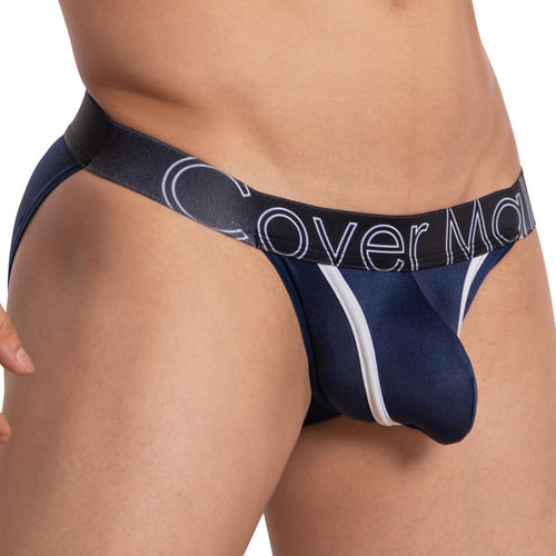 A close-up of someone wearing Cover Males Color Me Bikini in navy blue and black shows color-contrast piping and bold branding on the waistband. The lightweight fabric offers a form-fitting, minimalistic design for comfort and style.