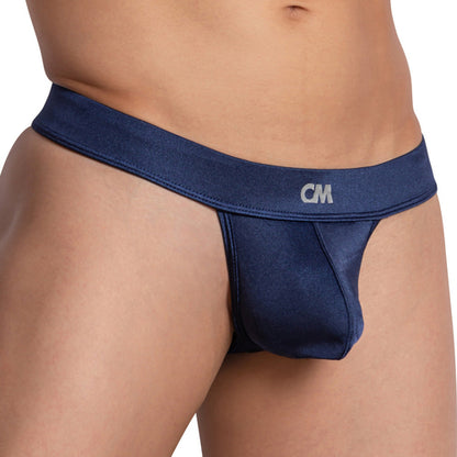 A person showcases a Perfect V-Shape Lift wearing Cover Male Love Me Thong, featuring smooth blue satiny fabric with a thick CM waistband and a breathable supportive pouch. The plain background enhances the glossy look.