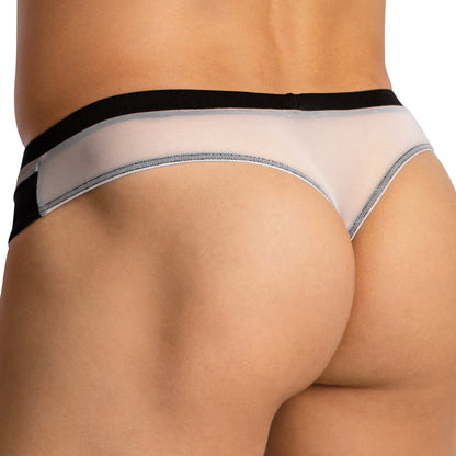 Close-up of a person’s lower back and buttocks wearing Cover Males Almost Naked Thong—sheer, light-colored mesh underwear with black trim and waistband—showcasing its ultra-comfortable fit and striking design.