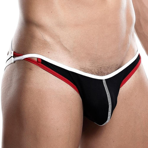 A person models black and red Daddy briefs with white trim in a side view. The sexy fit includes a hip cut-out and contoured pouch, echoing the stylish allure of the Daddy Jockstrap.