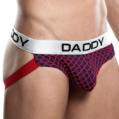 A person models the Daddy Jockstrap, flaunting its navy blue and red mesh-patterned design with red side straps, a form-fitting front, and a white waistband labeled DADDY.