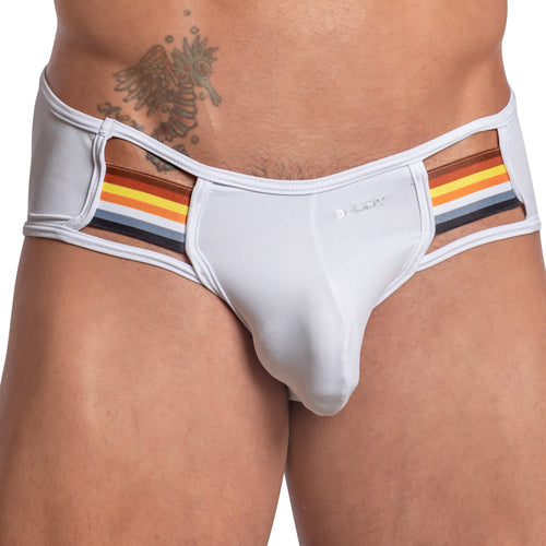 A person confidently wears the Daddy Seductive Gay Jockstrap by Daddy, featuring white briefs with bold red, yellow, and black striped side panels. An intricate tattoo adorns their upper body.
