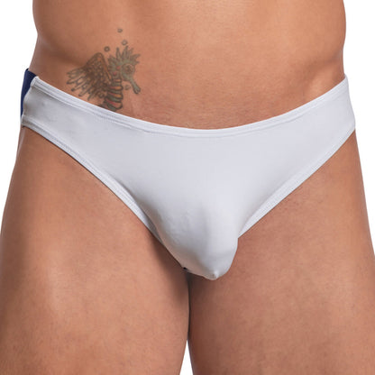 A person wearing a white Daddy Wide Waistband Jockstrap by Daddy, offering a supportive fit, displays a tattoo near the waist. The jockstrap features a blue stripe on the side, enhancing its sleek design.