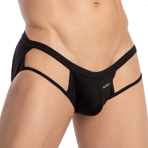 Wearing the Daddy Strapped Backless Jockstrap, a person sports stylish black underwear featuring provocative side cut-outs. The smooth fabric complements the boldly DADDY-printed waistband, adding an edgy flair.