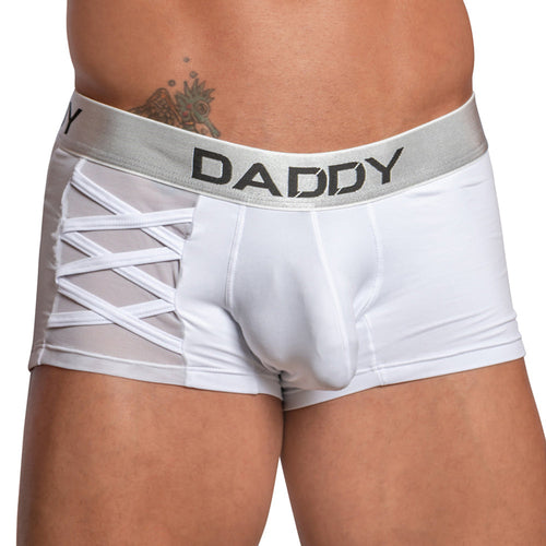 A person wears the Daddy Criss-Cross Side Mesh Boxer, featuring lattice cut-out designs on the sides and mesh fabric for a sleek touch. The metallic waistband has DADDY printed on it, with a partial tattoo visible above.