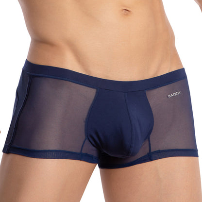 A person wears Daddys Enhanced Pouch Boxer Trunk in see-through navy blue, highlighting its breathable fabric and fit. The brand logo is prominently displayed on the waistband, showcasing style and comfort.