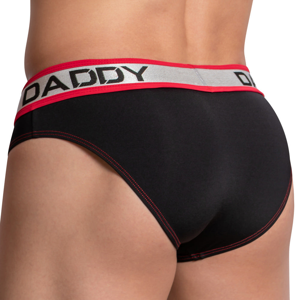 A person wearing Daddy Dazzler Briefs with bold red stitching and a white DADDY waistband. The shiny, stretchy fabric enhances the physique and accentuates the back for a striking impression.