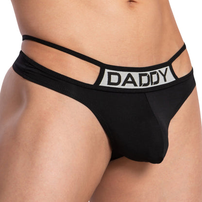A person models the Daddy Pyramid Thong by Daddy, featuring black fabric with a package-enhancing pouch, double waistbands displaying DADDY, and a V-shaped design that highlights the torso and upper legs for a distinct silhouette.