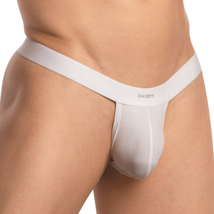 A confident person showcases the Daddy Strapped T-Back G-string, featuring Daddy on the waistband. The photo highlights waist and upper thighs, emphasizing its minimalistic allure and daring design.