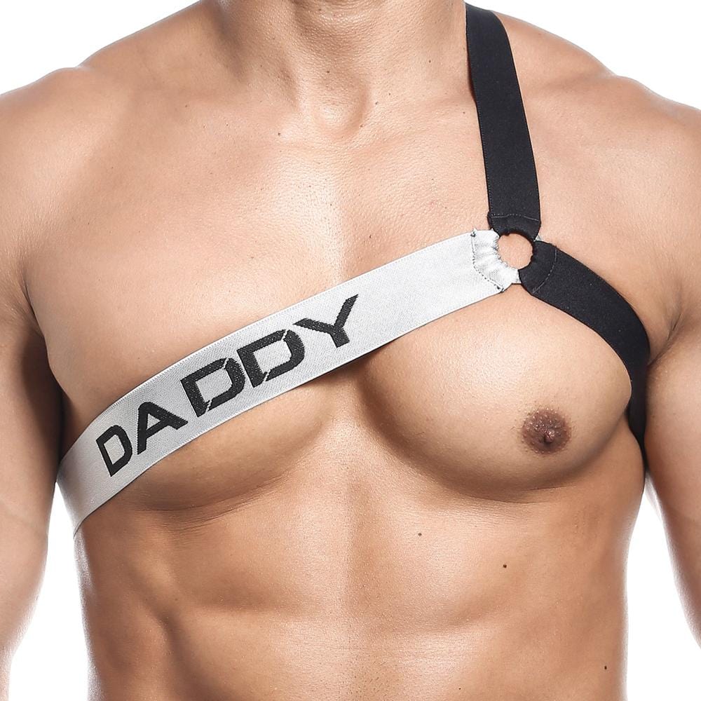 Someone confidently flaunts a bold black and white Daddy Harney Man Strap by Daddy. The asymmetrical three-strap design, displaying DADDY, stylishly exposes one shoulder.