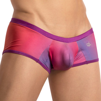 A person in Daniel Alexander Breathable Vibrant Boxer Trunk in red, pink, and purple demonstrates superior comfort, with a close-up of the lower torso and upper thigh against a white background.