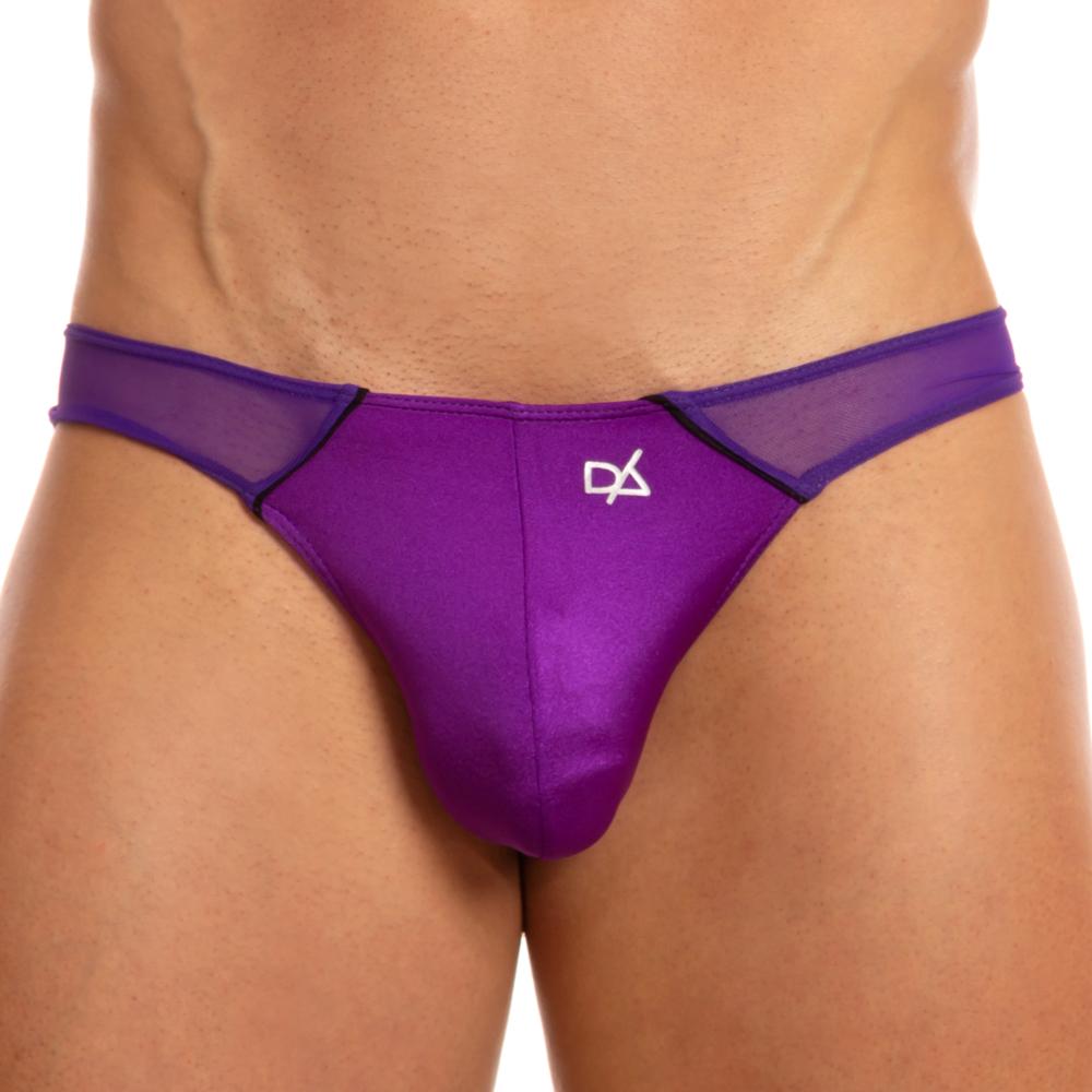 A person wears the Daniel Alexander Free Panels Bikini—a purple satin and mesh mens trendy underwear with a white logo. The polyamide-spandex blend offers a striking look, with sheer panels enhancing the style against the white background.