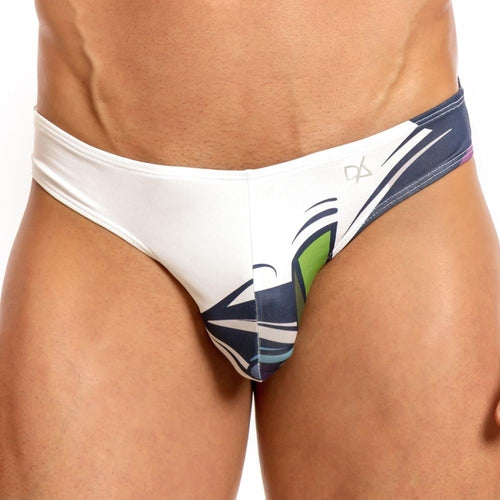 Close-up of someone wearing Daniel Alexanders Graffiti Bikini, with abstract green and blue designs. The plain white background highlights the vibrant patterns on these stylish mens swim briefs.