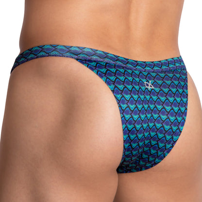Close-up of a person in a Daniel Alexander Mens Wave Bikini featuring a blue and green wave pattern. The shiny fabric highlights the fit and small side logo, emphasizing this stylish design by Daniel Alexander.