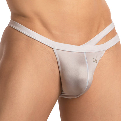 The image features a close-up of someone wearing the Daniel Alexander Dual Strapped Bikini, showcasing its light-colored satin finish and sleek design with thin side straps.