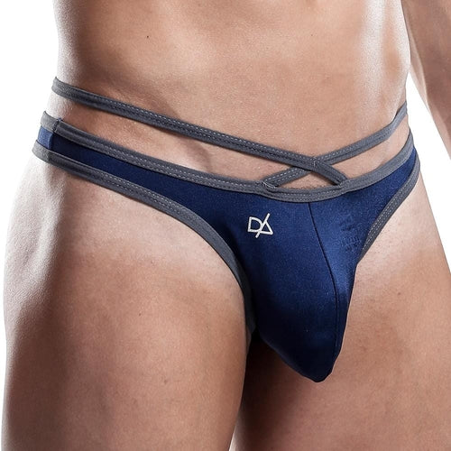 A close-up image displays a person wearing a Daniel Alexander Thong in navy blue and gray with double straps. The exotic string design includes a small logo on the left side, and the comfortable pouch enhances fit against a plain, neutral background.