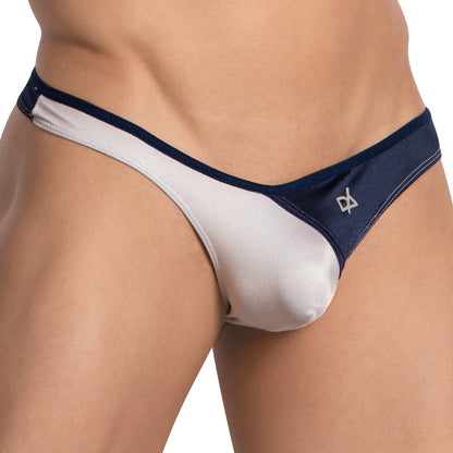 A person wearing the Daniel Alexander Bi-Color Pouch Thong in white and navy blue, featuring a discreet side logo and made from luxurious fabric for ultimate comfort.