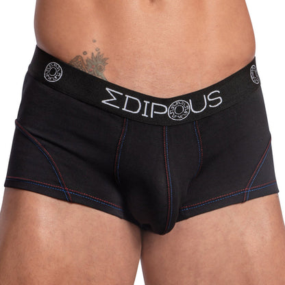 Someone is wearing Edipous Bi-Color Sports Boxer Trunks, featuring blue and red stitching with a branded EDIPOUS waistband. The supportive pouch offers comfort, and a tattoo is partly visible on the persons lower abdomen.