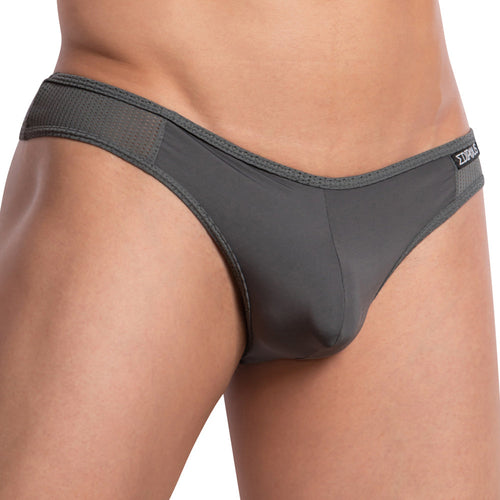 Close-up of a person wearing Edipous Maximilian Thong, featuring small square pattern waistband and smooth, stretchy fabric for a perfect fit. The backdrop is plain white.