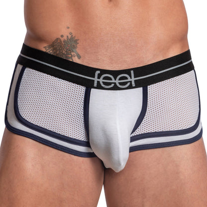 A person wearing Feel Sheet Sides Boxer briefs in white mesh with navy piping and a black waistband labeled Feel. The design includes breathable fabric, a contouring pouch, and reveals a tattoo on the left hip.