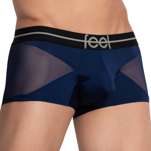 A close-up features a person in Feel Lustrous Sports Boxer Trunk, showcasing navy blue boxer briefs with black mesh panels and a supportive pouch. The waistband is black with thin grey stripes and feel branding, seamlessly blending into the stretchy cotton fabric against a plain white backdrop.