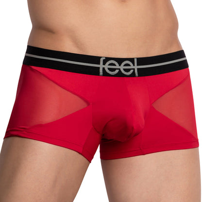A close-up shows a person wearing the Feel Lustrous Sports Boxer Trunk in red and black, with feel in gray on the waistband. Designed with mesh panels for style, it includes a supportive pouch made from stretchy cotton for comfort.