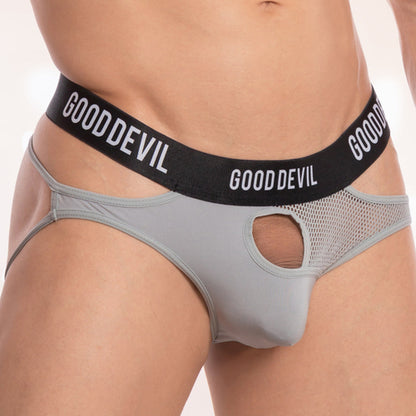 A person is wearing the Good Devil Bronco Jockstrap in grey and black mesh with a front cutout. This luxurious piece offers a supportive pouch for comfort, while the waistband boldly displays GOODDEVIL in white letters.
