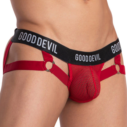 A person wearing the Good Devil Love me now Jockstrap with a black waistband that reads GOOD DEVIL. The red sheer design features side straps connected to metal rings for support. Focus: midsection.