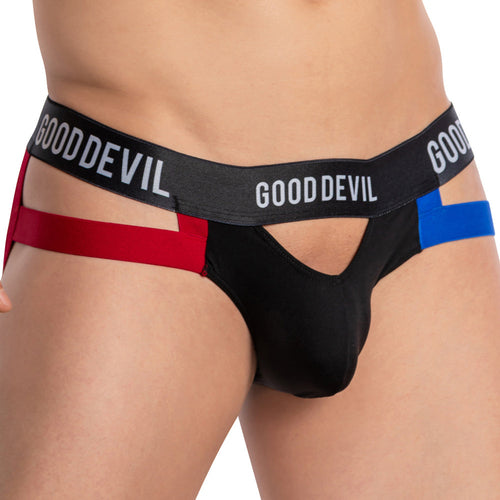 A person is wearing a daring Good Devil Open Pouch Backless Jockstrap, featuring black and red colors with cutouts on the sides, an elastic waistband labeled GOOD DEVIL, and a blue accent for a snug fit, focusing on hip and waist areas.