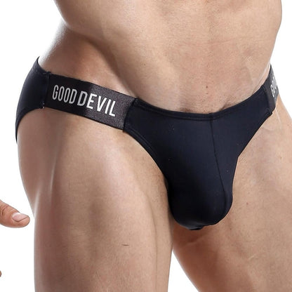 A person is wearing a sleek and alluring Good Devil Micro Bikini, with Good Devil prominently displayed on the waistband, emphasizing the stylish design of this sexy mens swimwear.